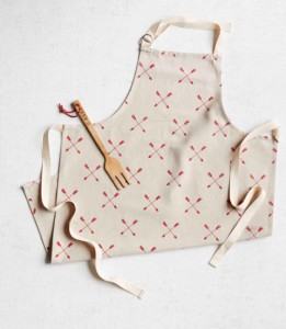 White apron with design and wooden fork on it